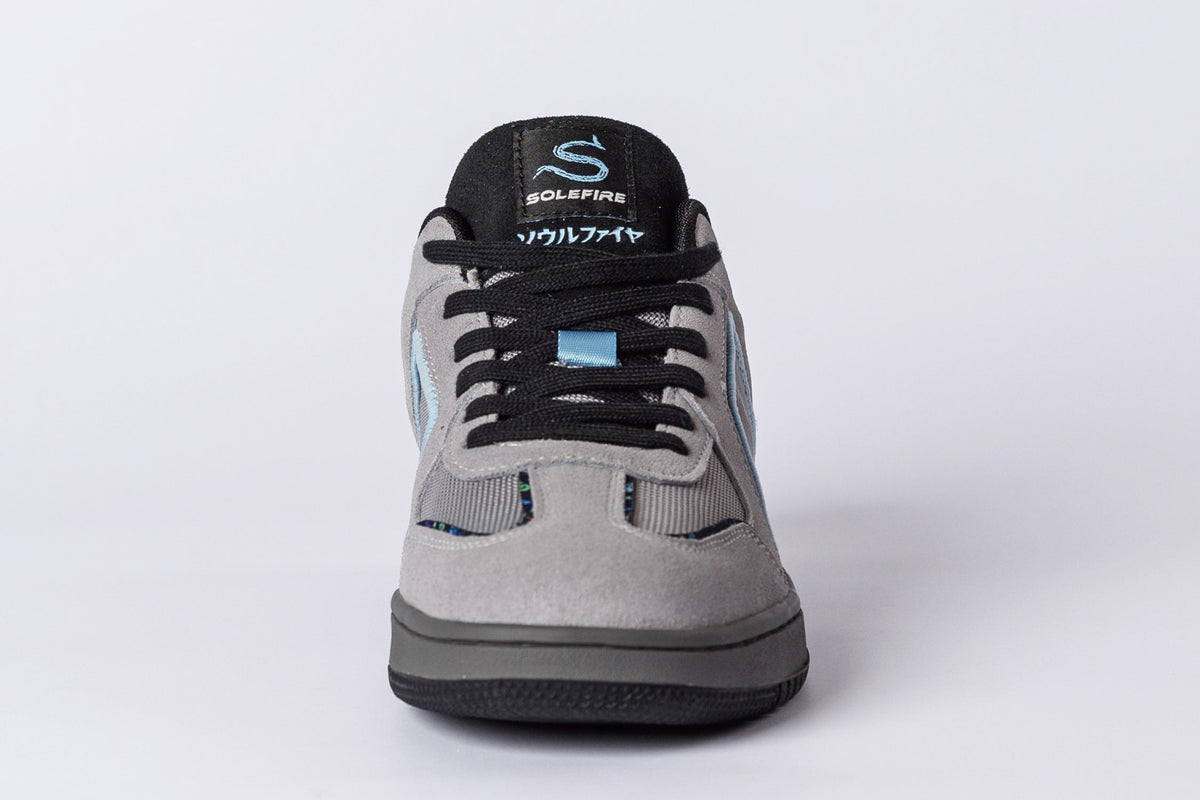 SOLEFIRE Tokyo Nights low-top sneaker in grey suede and black mesh with sky blue accents and branded tongue tag.