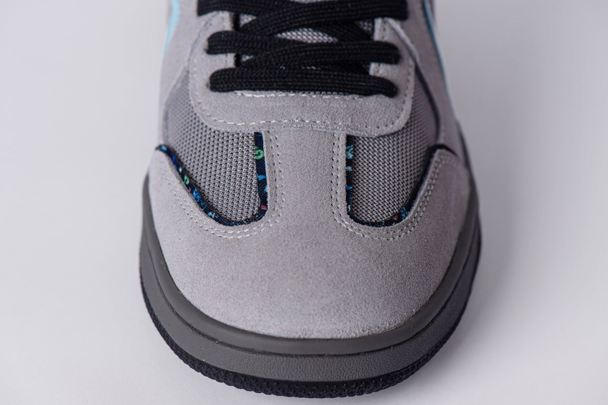 SOLEFIRE Tokyo Nights sneaker featuring light grey suede overlays, dark grey mesh panels, and black laces.