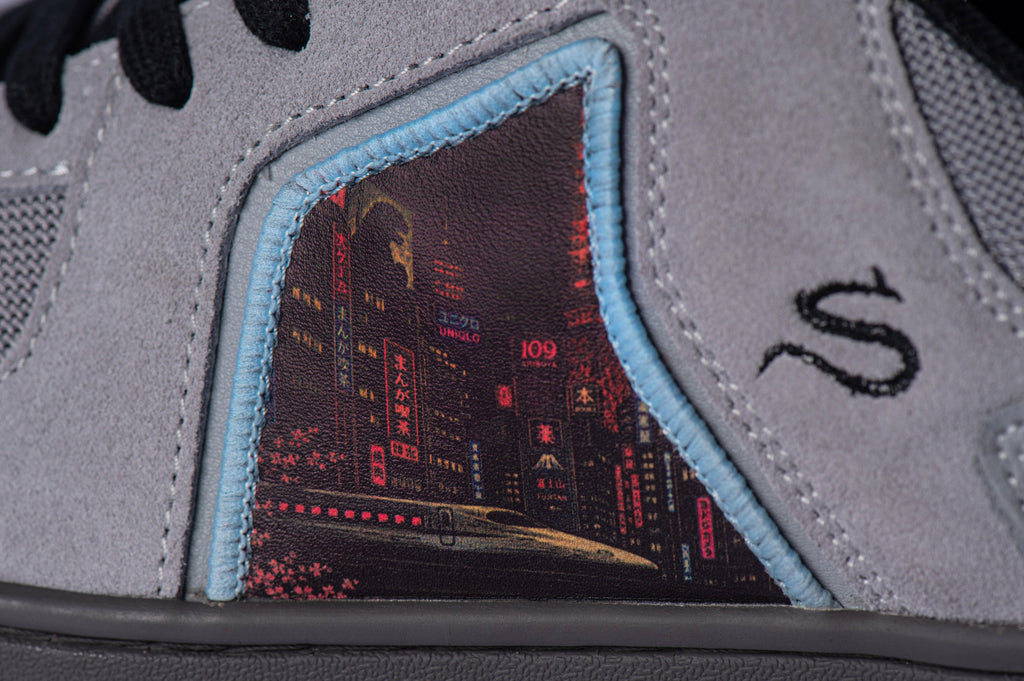 SOLEFIRE Tokyo Nights sneaker side detail featuring grey suede, dark mesh, and a vibrant Tokyo nightlife art panel.