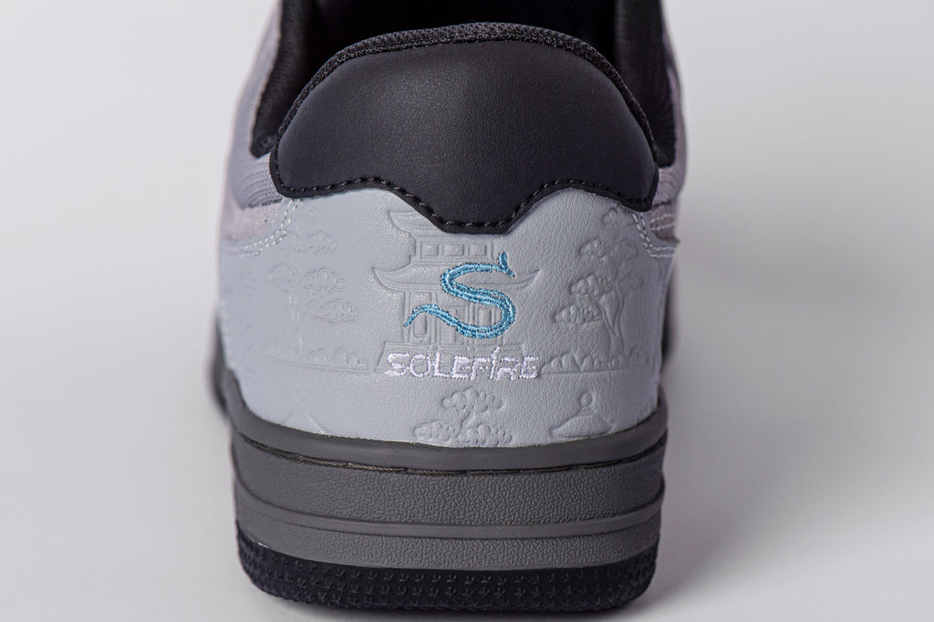 SOLEFIRE Tokyo Nights sneaker heel detail with embossed Japanese landscape, sky blue S logo, and grey leather panel.